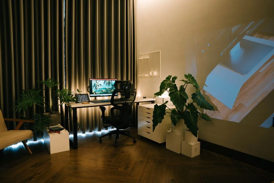 A sleek office desk setup featuring Apple devices: iMac, MacBook, and iPad.